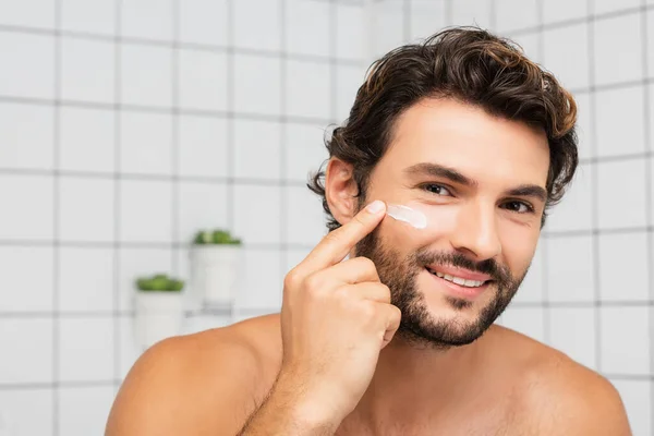 Smiling Man Applying Cosmetic Cream Face Bathroom — Stock Photo, Image