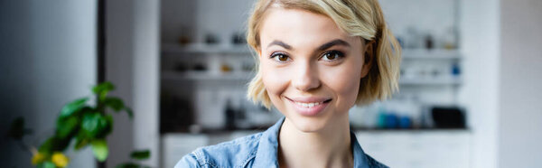 young blonde woman smiling, horizontal banner