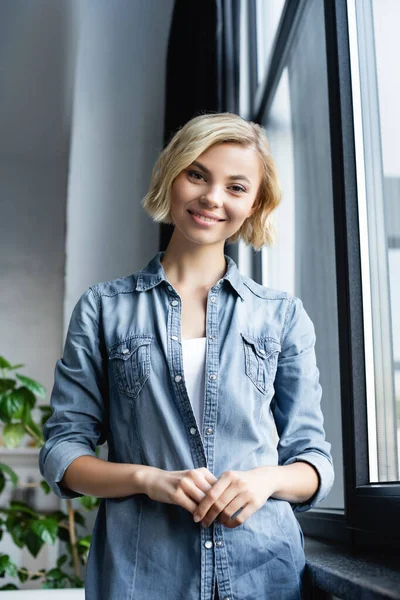 Portrait Smiling Blonde Woman Standing Window — Stock Photo, Image