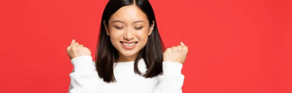 Happy Young Asian Woman Closed Eyes Rejoicing Isolated Red Banner — Stock Photo, Image