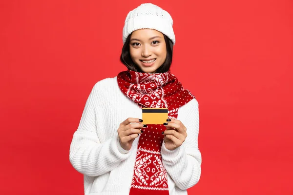 Smiling Asian Woman Hat Scarf Holding Credit Card Isolated Red — Stock Photo, Image