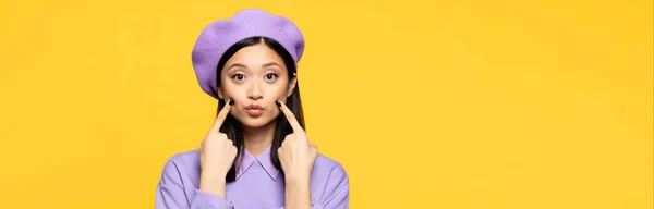 Asian Woman Beret Touching Cheeks Fingers While Pouting Lips Isolated — Stock Photo, Image