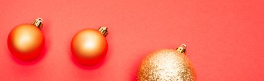 top view of shiny baubles on red background, banner clipart