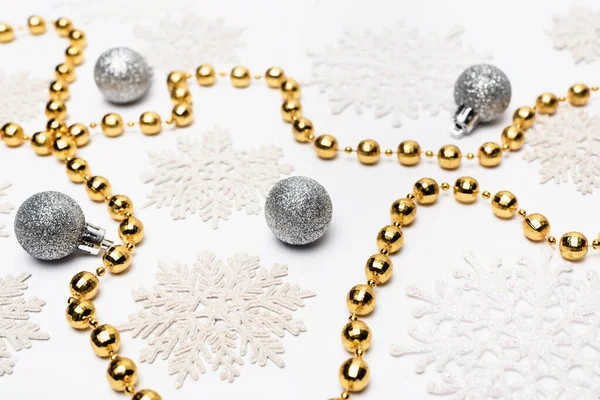 silver and golden Christmas decoration with snowflakes on white background