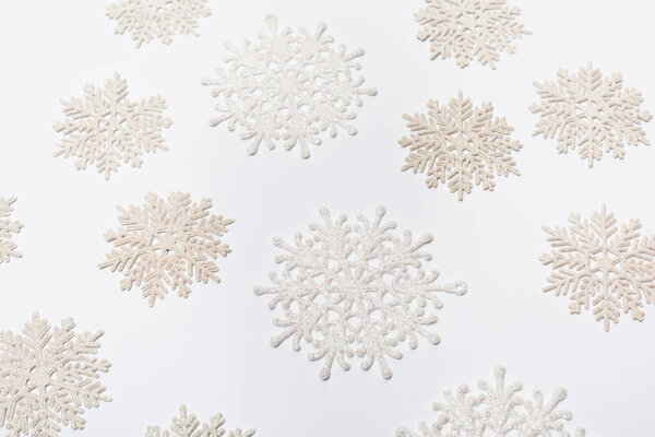 composition with winter snowflakes on white background