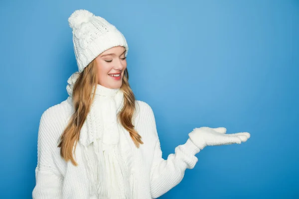 Smiling Beautiful Woman Winter White Outfit Pointing Hand Isolated Blue — Stock Photo, Image