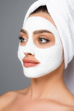 Kafasında havlu, yüzünde kil maske olan kadın gride izole edilmiş.