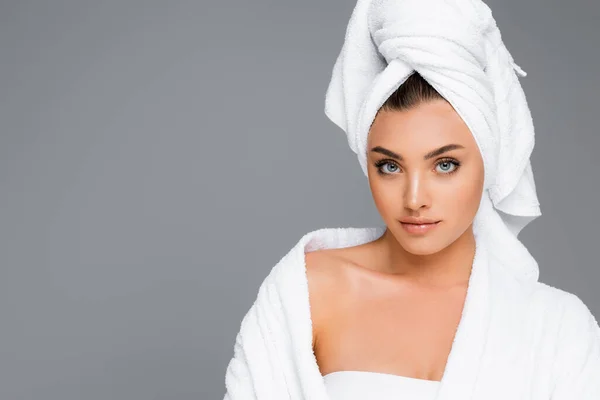 woman with towel on head isolated on grey