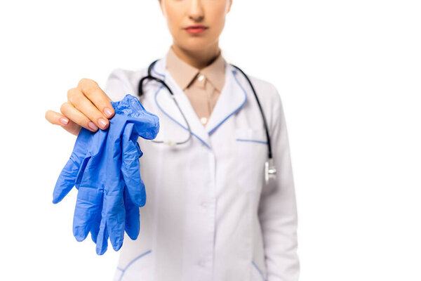 Cropped view of doctor holding latex gloves isolated on white