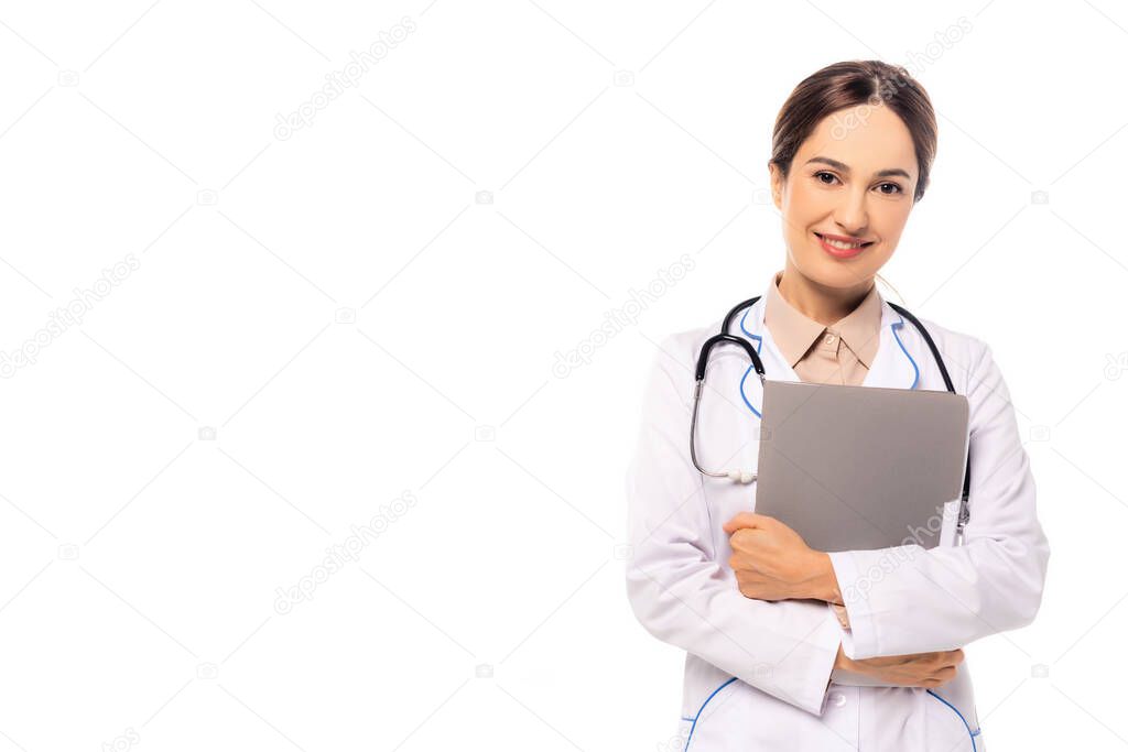 Smiling doctor in white coat holding paper folder isolated on white