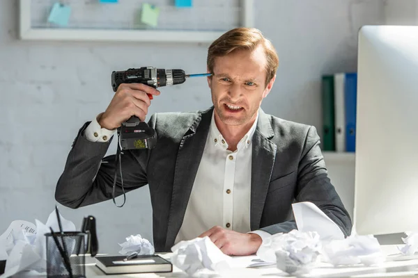 Aggressive Office Worker Holding Drill Head While Sitting Workplace Crumpled — Stock Photo, Image