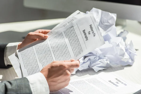 Cropped View Businessman Holding Petition Bankruptcy Pile Crumbled Papers Blurred — Stock Photo, Image