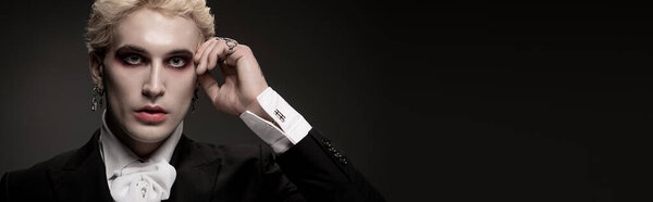 Красивый молодой человек позирует в сложном костюме на Хэллоуин, подчеркивая свой творческий вид и стиль.