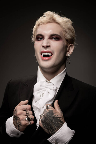 A young handsome man shows off his striking Halloween costume while posing confidently.