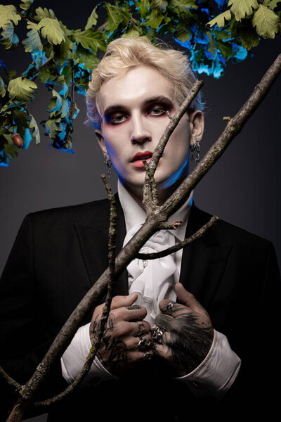 Handsome young man showcases an epic Halloween costume, blending elegance and spooky style.