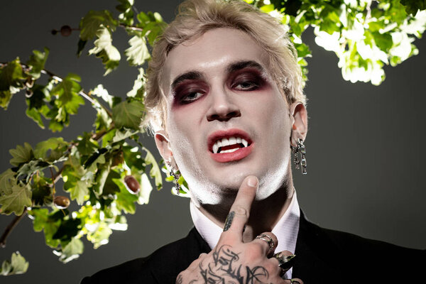 A young man shows off his impressive Halloween costume in a lively setting.