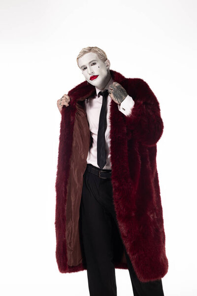 Young man shows off his stunning Joker costume, blending charm and excitement for Halloween.