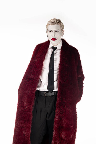 Young man dressed as Joker, showcasing an epic costume for Halloween festivities.