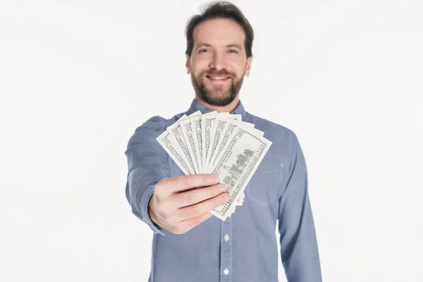 Smiling bearded man showing dollar banknotes in hand isolated on white — Stock Photo