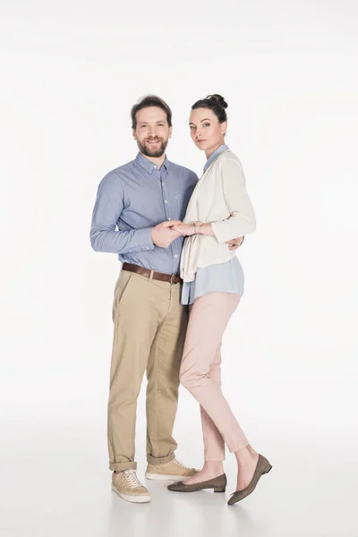 Married couple holding hands together and looking at camera isolated on white — Stock Photo