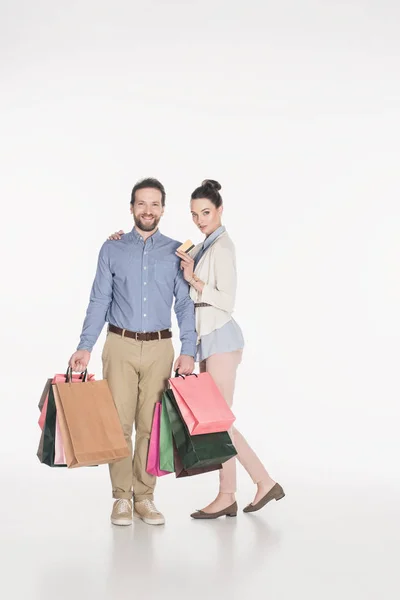 Paar mit Einkaufstaschen und Kreditkarte isoliert auf weißem Grund — Stockfoto