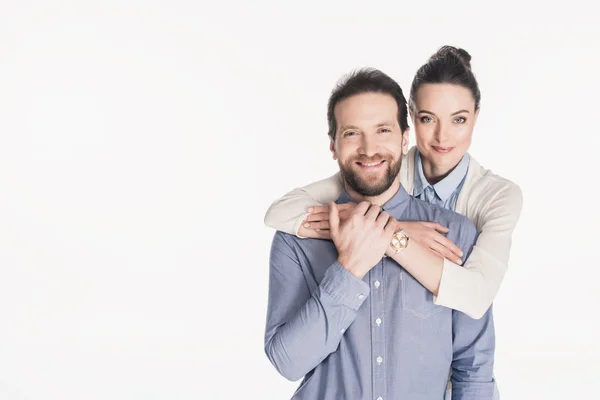 Portrait of woman hugging smiling husband isolated on white — Stock Photo