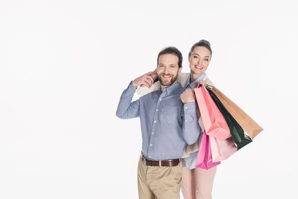Casal alegre com sacos de compras isolados em branco — Fotografia de Stock