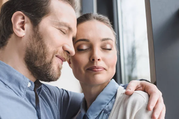 Portrait of beautiful smiling couple with eyes closed — Stock Photo