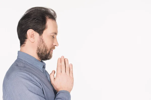 Side view of bearded man in shirt praying isolated on white — Stock Photo