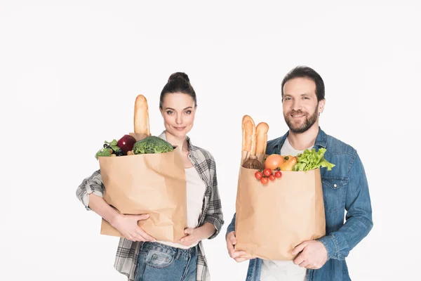 Portrait of wife and husband holding paper packages with food isolated on white — Stock Photo