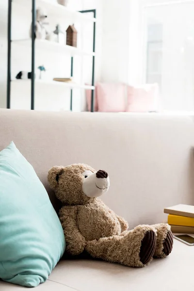 Close-up shot of cute teddy bear on couch at home — Stock Photo