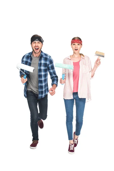 Screaming couple in headbands with paint rollers and paint brush isolated on white background — Stock Photo