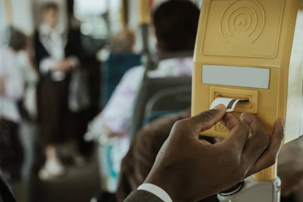 Обрезанный вид африканского американского бизнесмена, использующего свой билет на транспорт — стоковое фото