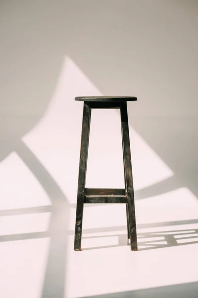 Single empty tall wooden stool on white — Stock Photo