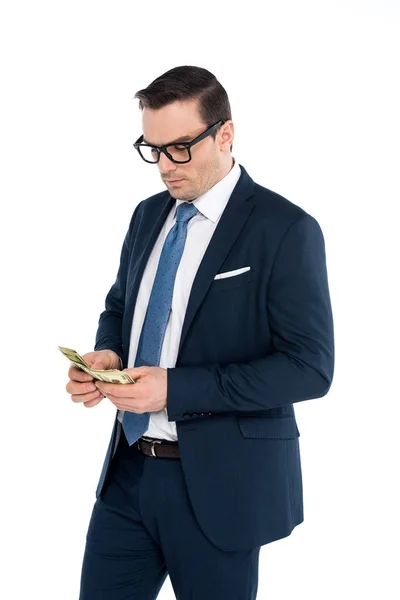 Handsome businessman in eyeglasses counting dollar banknotes isolated on white — Stock Photo