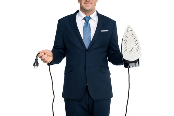 Cropped shot of smiling businessman holding iron and plug isolated on white — Stock Photo