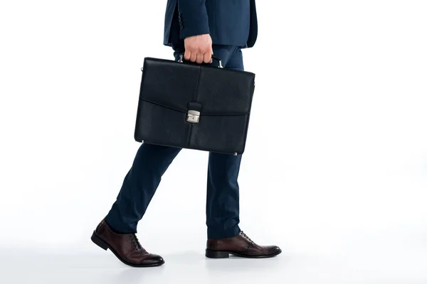Cropped shot of businessman holding briefcase and walking on white — Stock Photo
