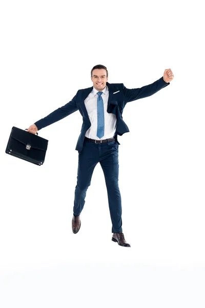 Excited businessman with briefcase jumping and smiling at camera isolated on white — Stock Photo