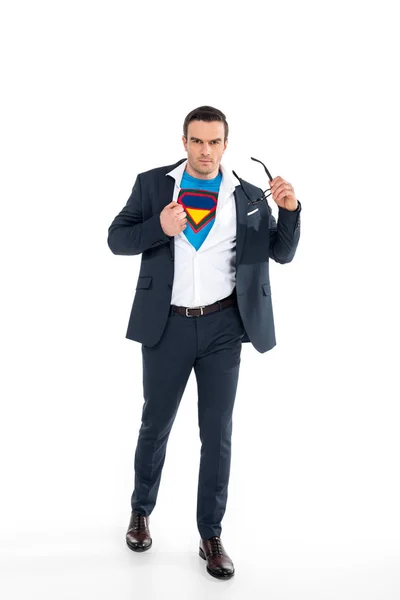 Confident businessman in superhero costume under suit taking off eyeglasses and looking at camera isolated on white — Stock Photo