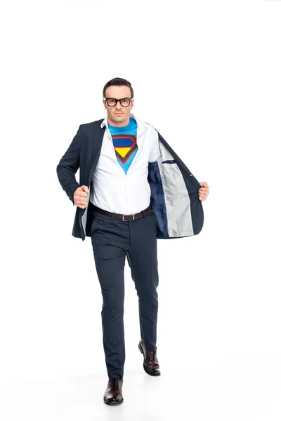 Confident businessman in superhero costume under suit taking off suit jacket and looking at camera isolated on white — Stock Photo