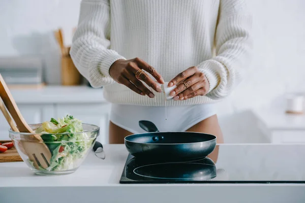 Tiro recortado de mujer freír huevo revuelto para el desayuno en la cocina - foto de stock