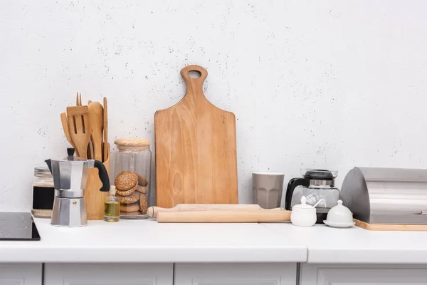 Various wooden kitchenware on table at kitchen — Stock Photo