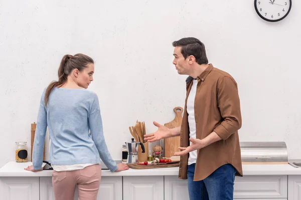 Side view of adult couple having argument at kitchen — Stock Photo