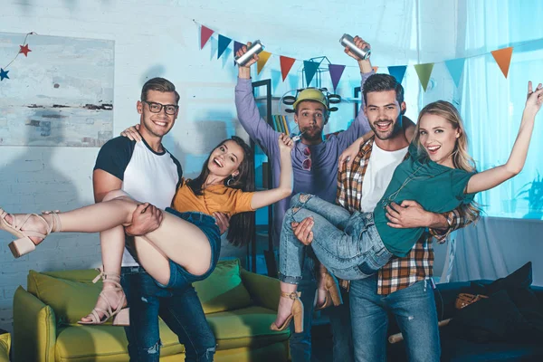 Happy young people smiling at camera while having fun and partying together — Stock Photo