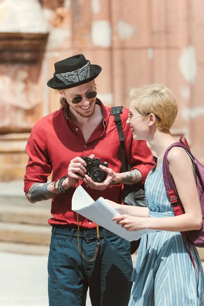 Belo casal de turistas com câmera de fotos e mapa — Fotografia de Stock