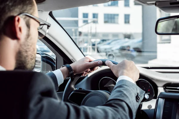 Selective focus of businessman driving car alone — Stock Photo