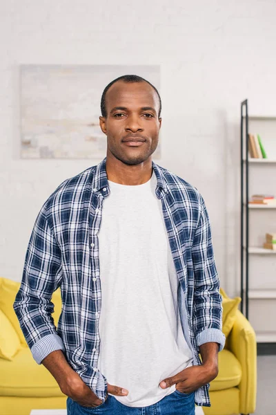 Handsome young african american man looking at camera at home — Stock Photo