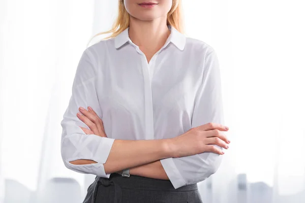 Cropped image of smiling female therapist with crossed hands — Stock Photo