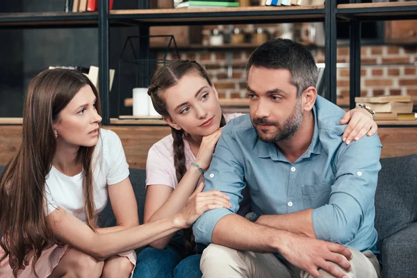 Careful family cheering up man on therapy session in office of counselor — Stock Photo