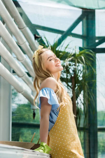 Vista laterale di ragazza felice con gli occhi chiusi rilassante in serra — Foto stock